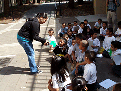 Euphrat student intern Rojana Ibarra talks about her artwork with students of Arbuckle Elementary School of the Alum Rock School District.  She and Euphrat student intern Trang Tran worked with Arbuckle students on a hands-on art activity after a Teaching Tour of the Euphrat Museum.